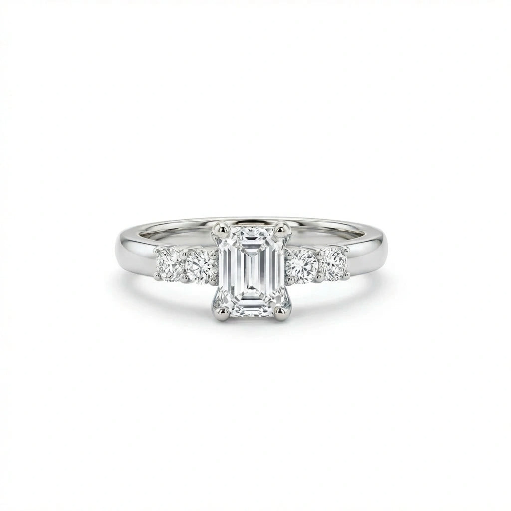 Emerald cut five-stone engagement ring in 14K white gold, front view with four graduated round side stones