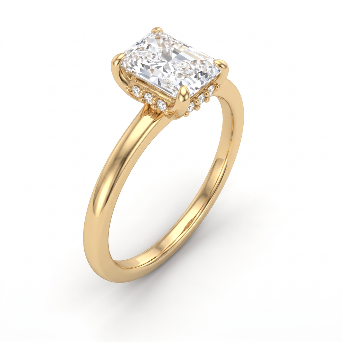 Angled view of emerald cut hidden halo engagement ring in 14K yellow gold showing the concealed pave under the center stone