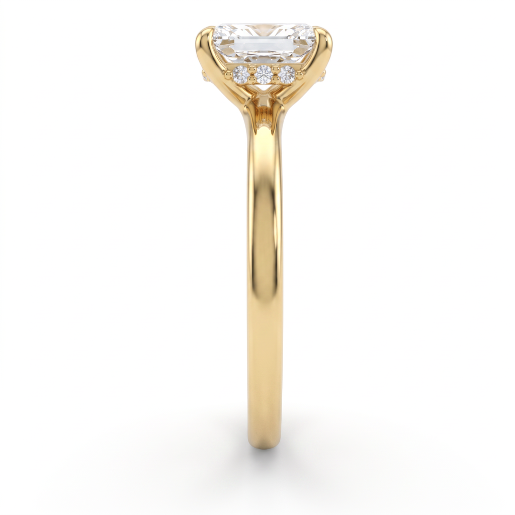 Side profile of emerald cut hidden halo engagement ring in 14K yellow gold showing the halo beneath the crown and 2mm band