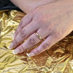 Woman wearing 3mm faceted gold wedding ring on her hand