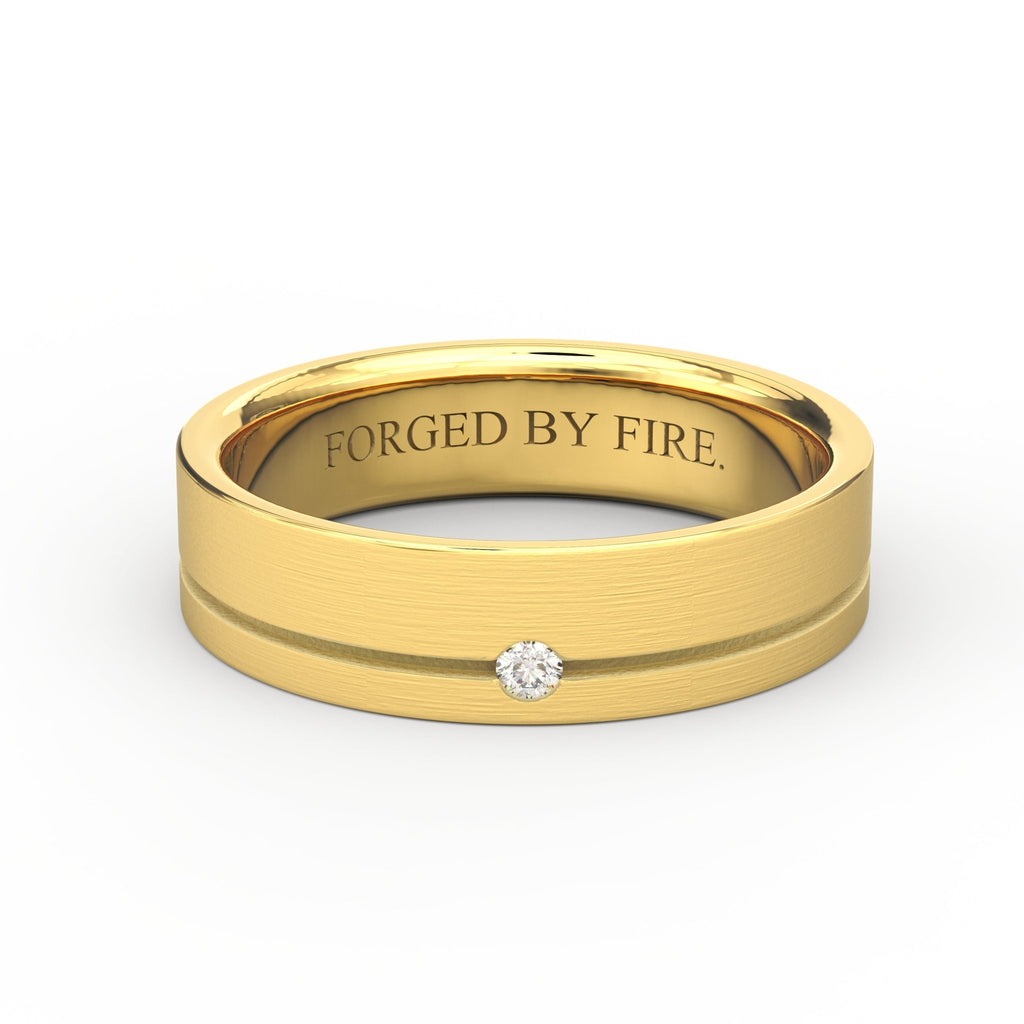 Men’s 5.5mm 14K gold diamond wedding band with brushed finish and interior engraving “Forged by Fire”