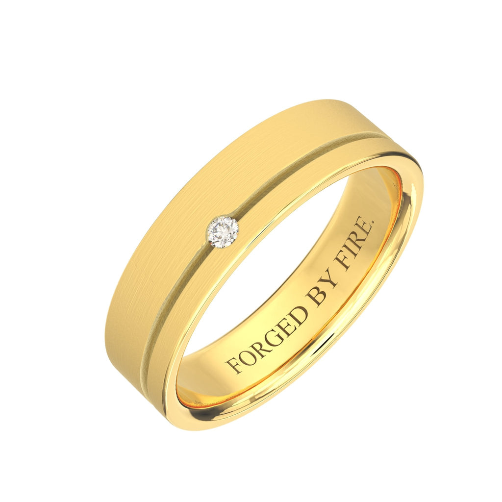 Angled view of men’s 14K gold wedding band with single diamond, brushed center, and engraved interior message