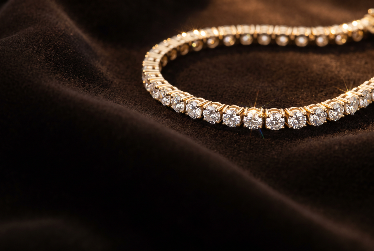 Four-prong lab-grown diamond tennis bracelet in 14K yellow gold on dark velvet