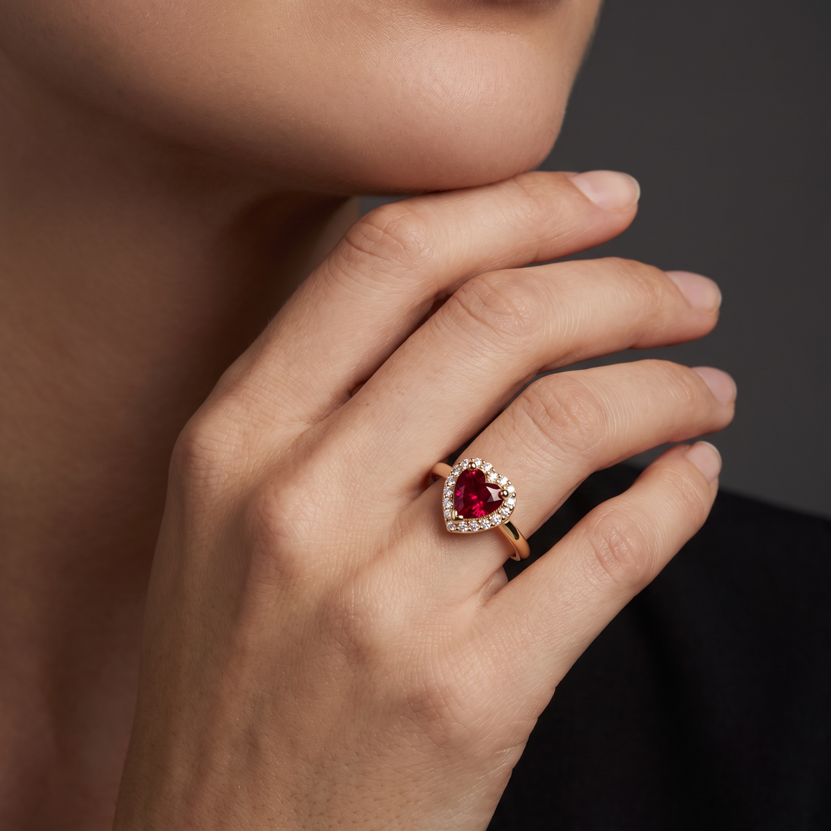 Heart-shaped Lab-Created Ruby halo ring in 14K rose gold worn on the hand