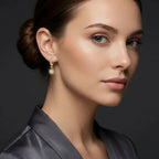 Woman wearing Helion diamond starburst hoop earrings with radiant drop design and pavé diamond detailing