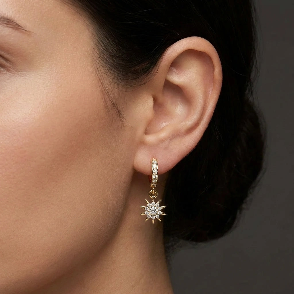 Helion diamond starburst hoop earrings in solid gold with pavé diamonds and radiant sunburst drop design