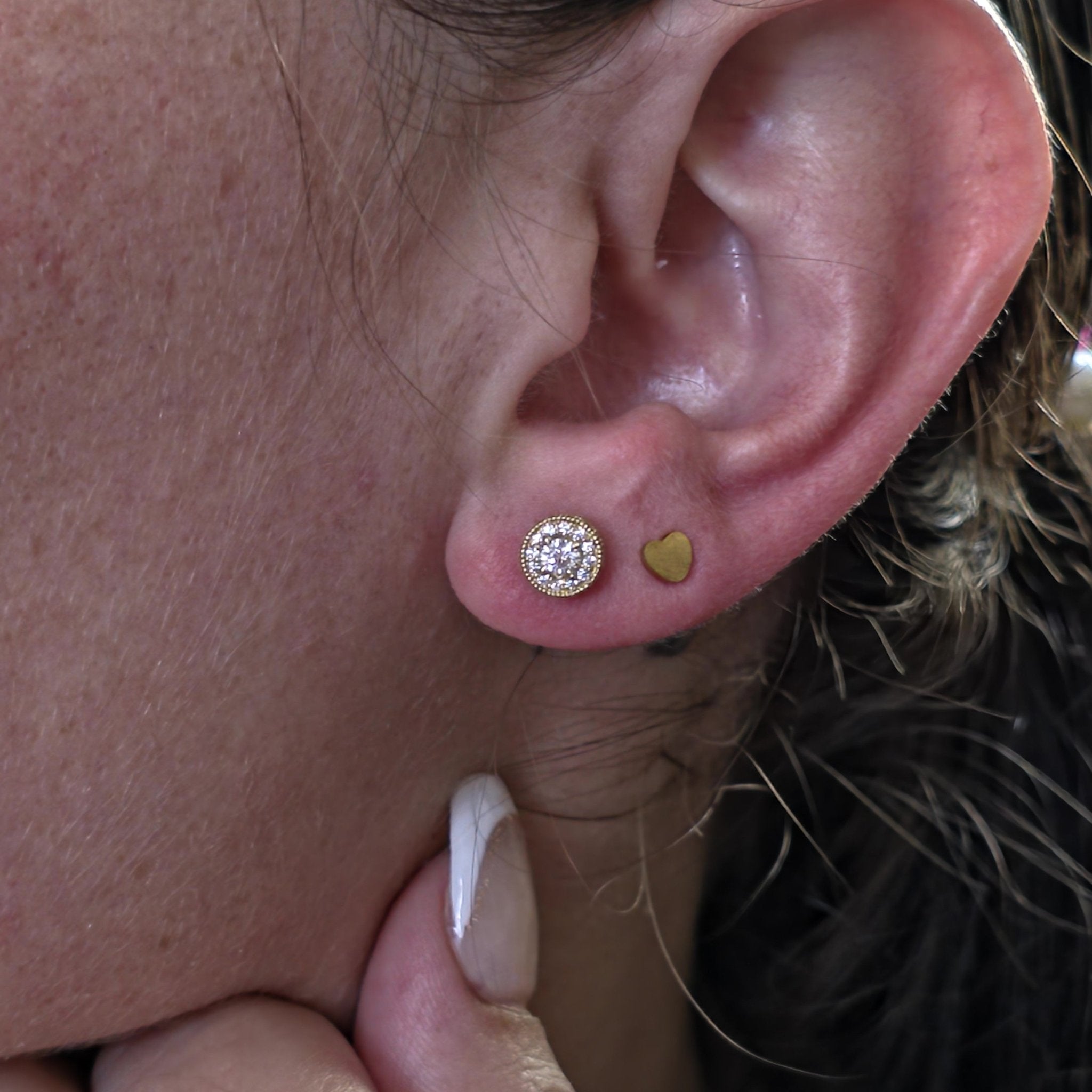Hidden Halo Diamond Earrings in 14K Yellow Gold with lab-grown diamonds shown on ear – Black Pearl of Queens