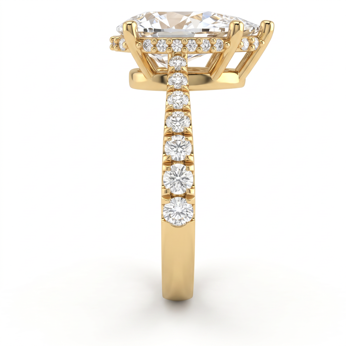 Close-up of the hidden halo and pavé shoulders on a 14K yellow gold Pear Cut Lab-Grown Diamond engagement ring