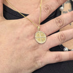 ICNIKA Gold pendant with diamonds in hand showing actual size