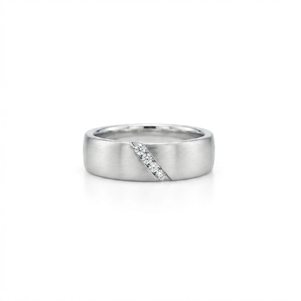 Men’s diamond wedding band in 14K white gold with diagonal channel set round diamonds and matte brushed surface

