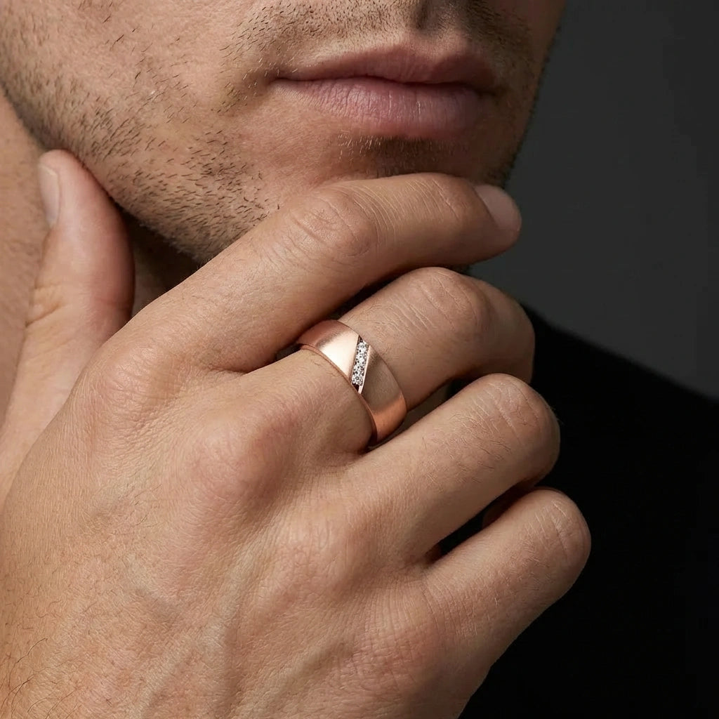 Men wearing diagonal diamond band in 14K rose gold with angled channel set diamonds and polished edges