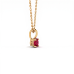 Side profile of the Lab-Created Ruby pendant in 14K yellow gold, showing the open gallery beneath the stone that lets light through