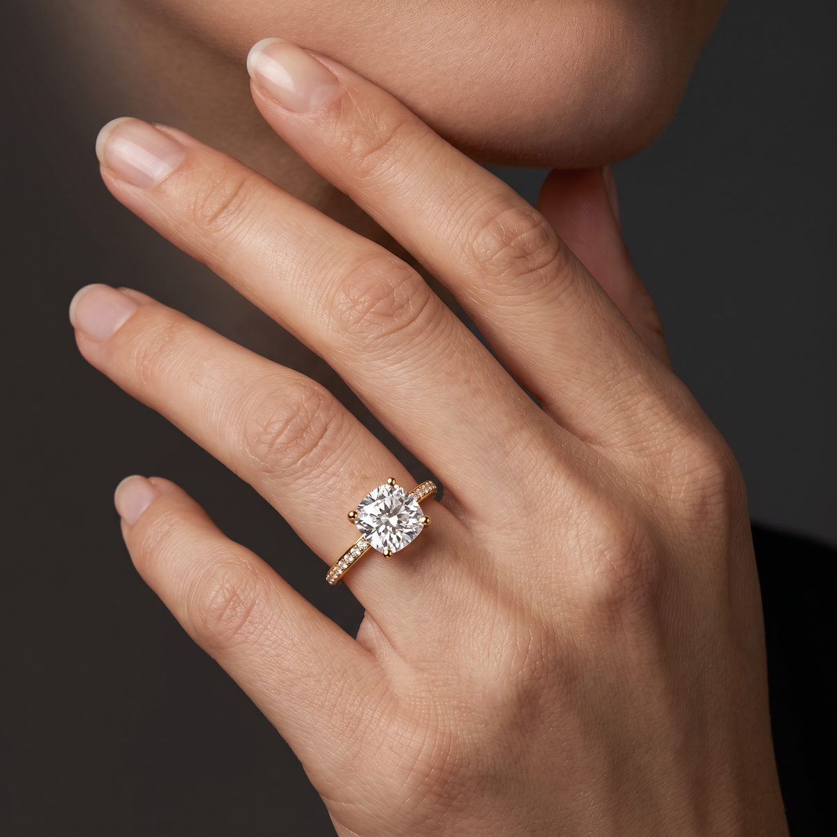 Hand wearing a cushion cut Lab-Grown Diamond pavé engagement ring in 14K yellow gold