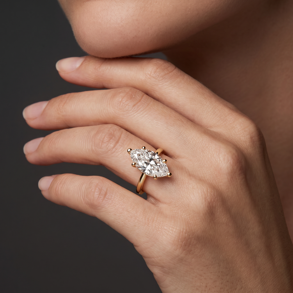 Hand wearing a marquise Lab-Grown Diamond solitaire engagement ring in 14K white gold