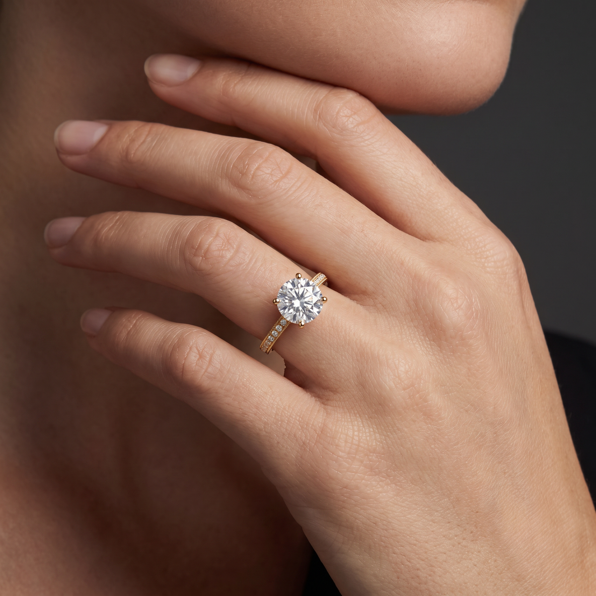 Hand wearing a round Lab-Grown Diamond milgrain pavé engagement ring in 14K white gold