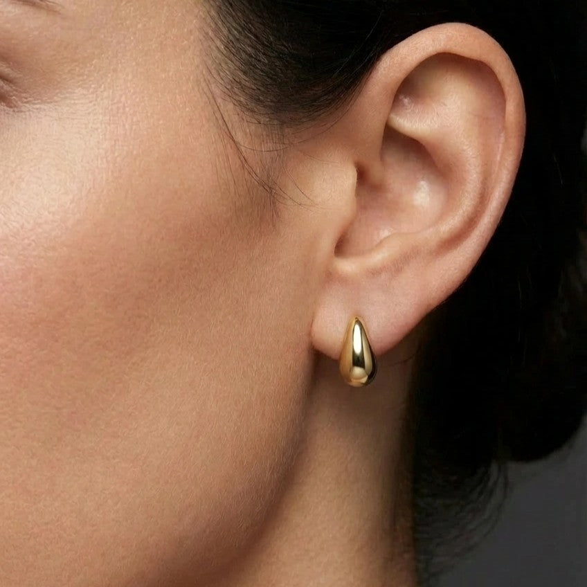 Woman wearing Lumi Teardrop Gold Stud Earrings in 14K gold minimalist everyday stud earrings