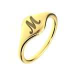 Gold ring with a letter 'M' engraving on a white background