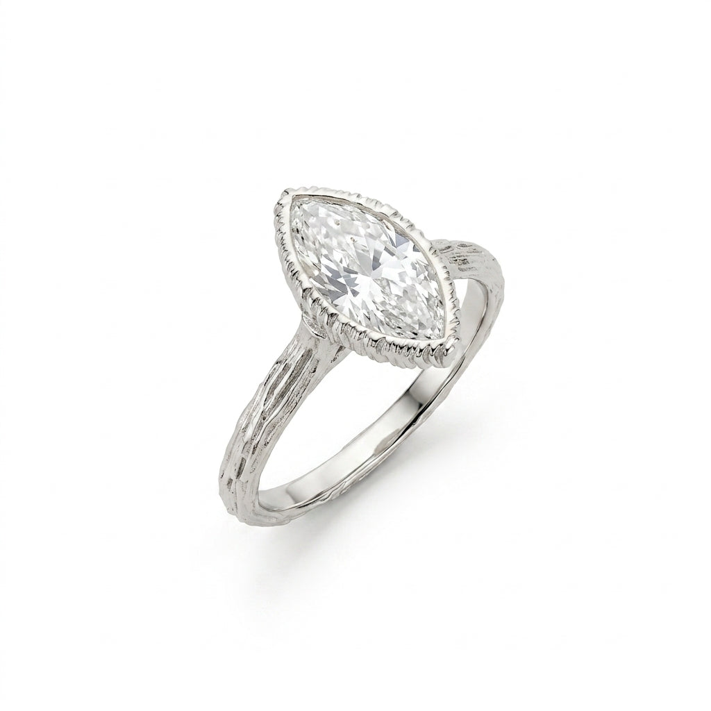 Marquise Lab-Grown Diamond engagement ring, angled view of the bezel-set stone and bark-textured branch band in 14K white gold