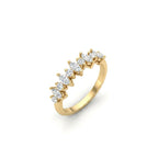 Angled view of marquise and round lab grown diamond wedding band in 14K yellow gold