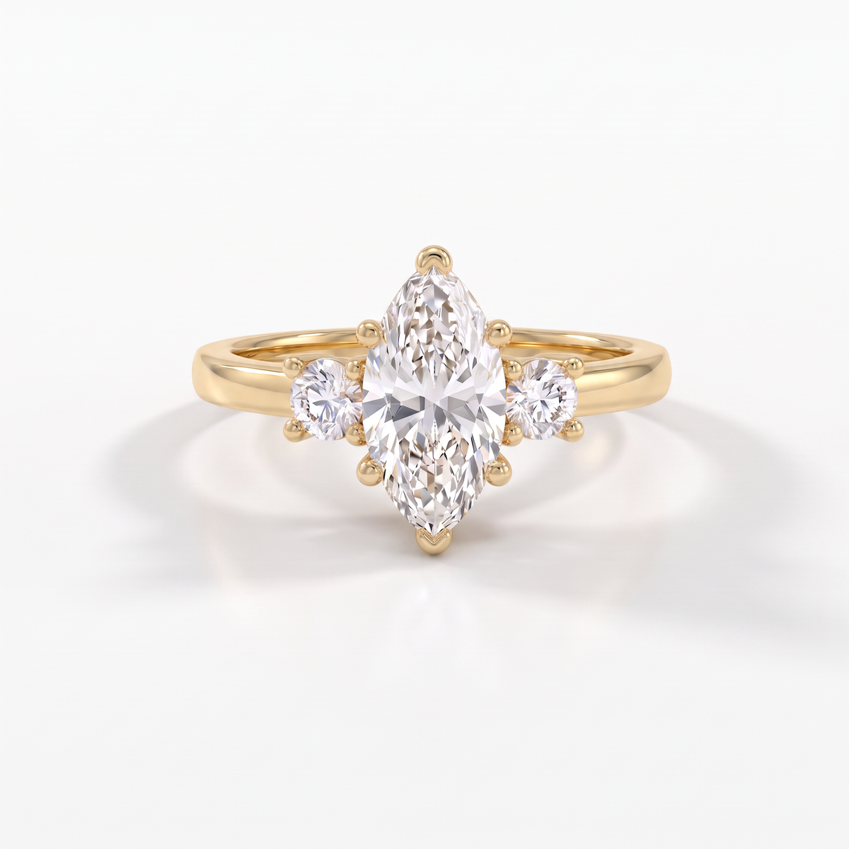 Marquise three-stone engagement ring in 14K yellow gold, V-prongs capping both points of the 1ct Lab-Grown Diamond