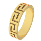 Angle view of solid gold Greek key ring with meander design on white surface