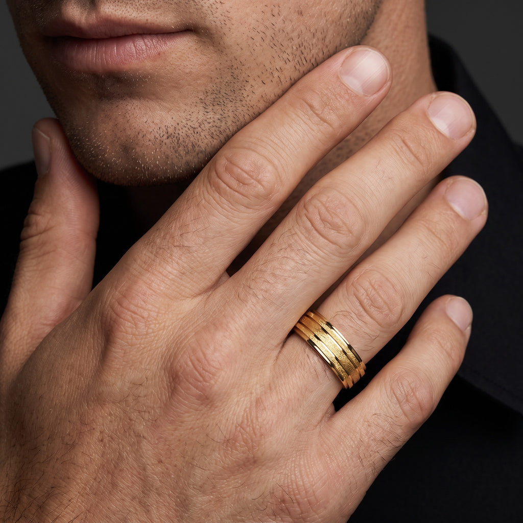Man wearing a 7mm ice finish grooved wedding band in 14K yellow gold, showing the textured stripes and polished grooves on the finger
