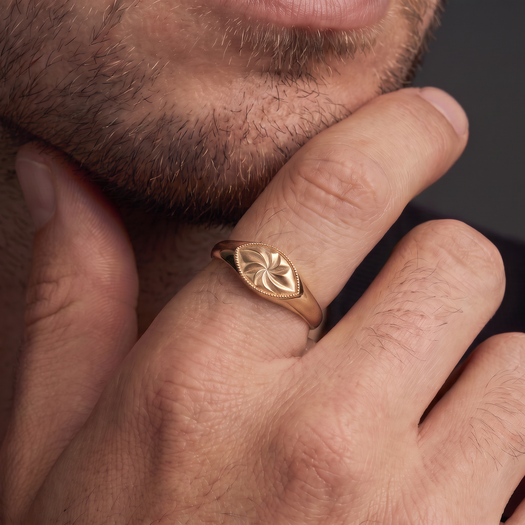 Man wearing the hand-engraved marquise signet ring in 14K rose gold on his ring finger