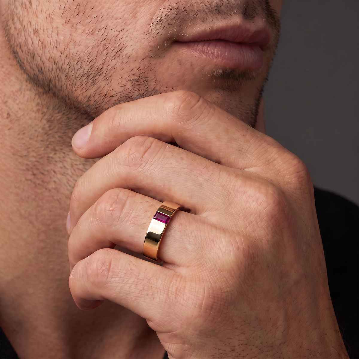 Man wearing a 5mm rose gold wedding band with a red Lab-Created Ruby baguette