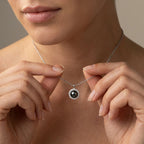 Model wearing black pearl halo pendant with diamond surround in solid gold on fine chain necklace