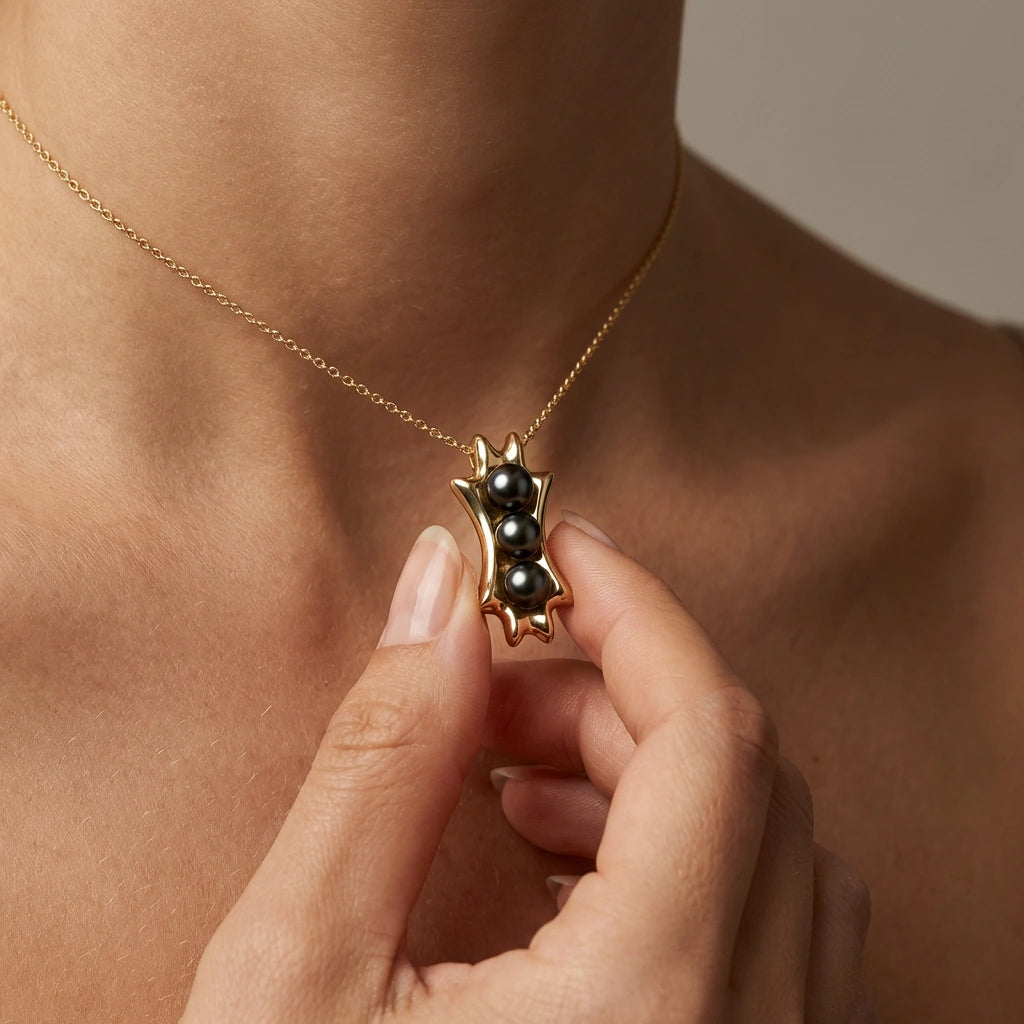 Noir Astra Trinity Black Pearl Pendant in solid 14K yellow gold, triple black pearl necklace worn on model