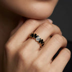 Close-up of 14K rose gold Noir Heart eternity band with black enamel worn on hand