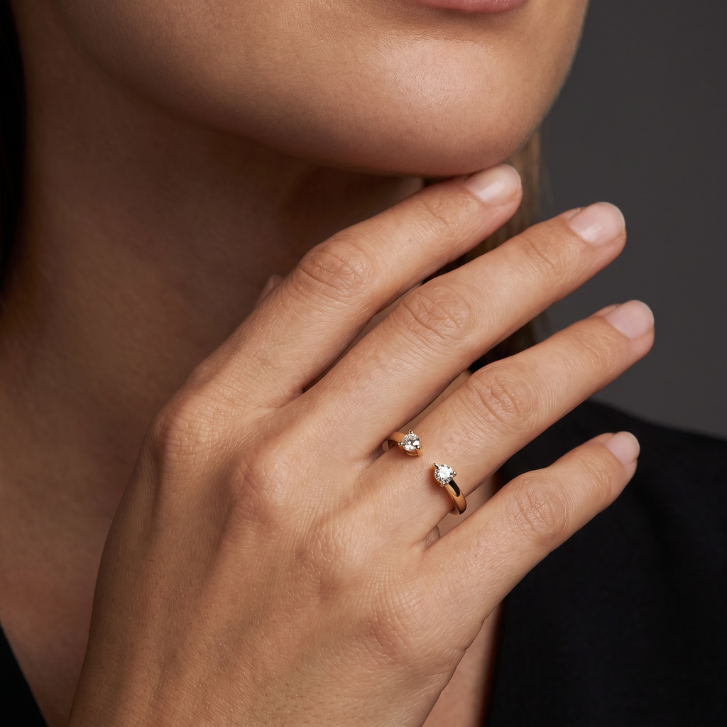 Hand wearing an open toi et moi wedding band with two round Lab-Grown Diamonds in 14K yellow gold