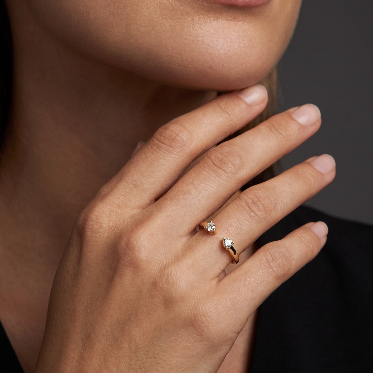 Hand wearing an open toi et moi wedding band with two round Lab-Grown Diamonds in 14K yellow gold