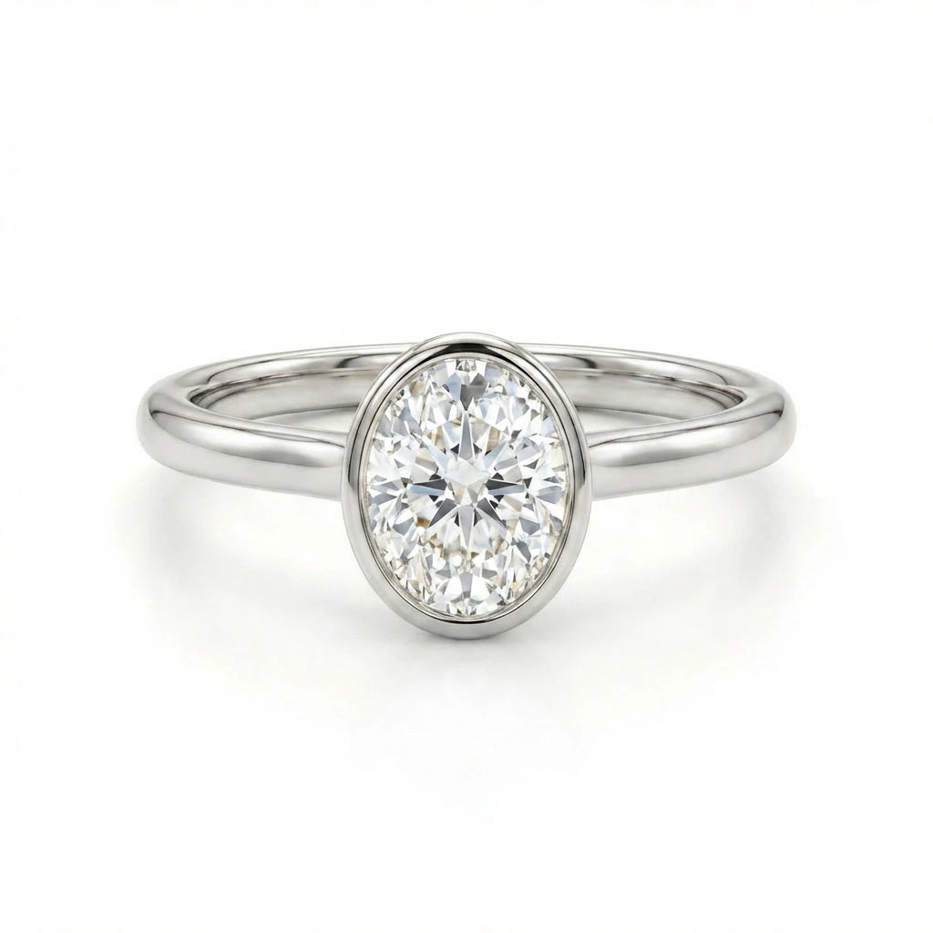 Solid 14K white gold oval cut diamond ring with smooth bezel setting and minimalist band
