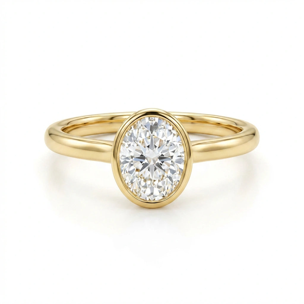 Solid 14K yellow gold oval cut diamond ring with bezel setting and polished slim band