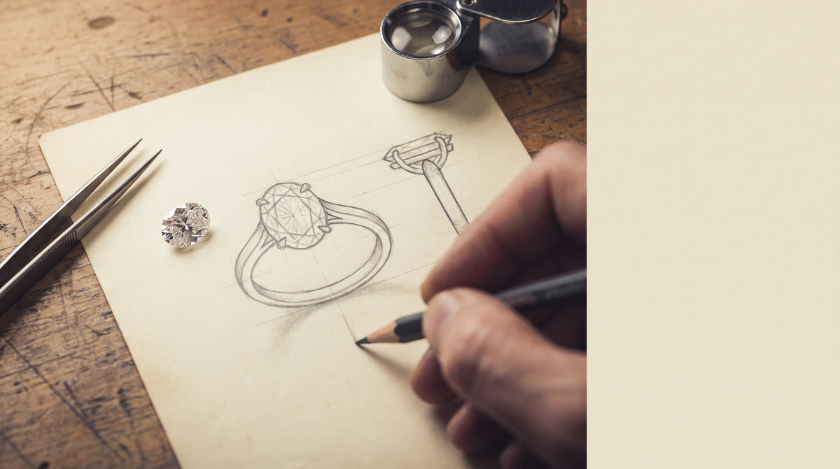 Hand-drawn technical sketch of an oval diamond engagement ring on a jeweler's bench, with a loose oval-cut diamond resting on the drawing