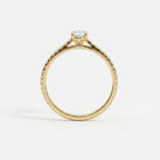 Side profile of oval lab-grown diamond pavé engagement ring in 14K yellow gold with cathedral setting