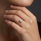 Woman wearing an oval lab-grown diamond pavé engagement ring in solid 14K yellow gold with a thin band setting