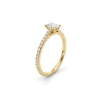 Angled view of oval pavé thin band engagement ring in solid 14K yellow gold with lab-grown diamond