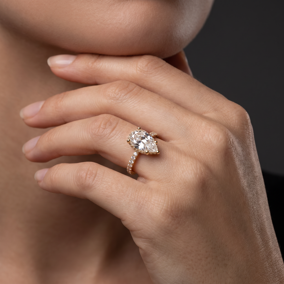 2.5ct Pear Cut Lab-Grown Diamond engagement ring worn on the hand, showing the 14K gold pavé band on the finger