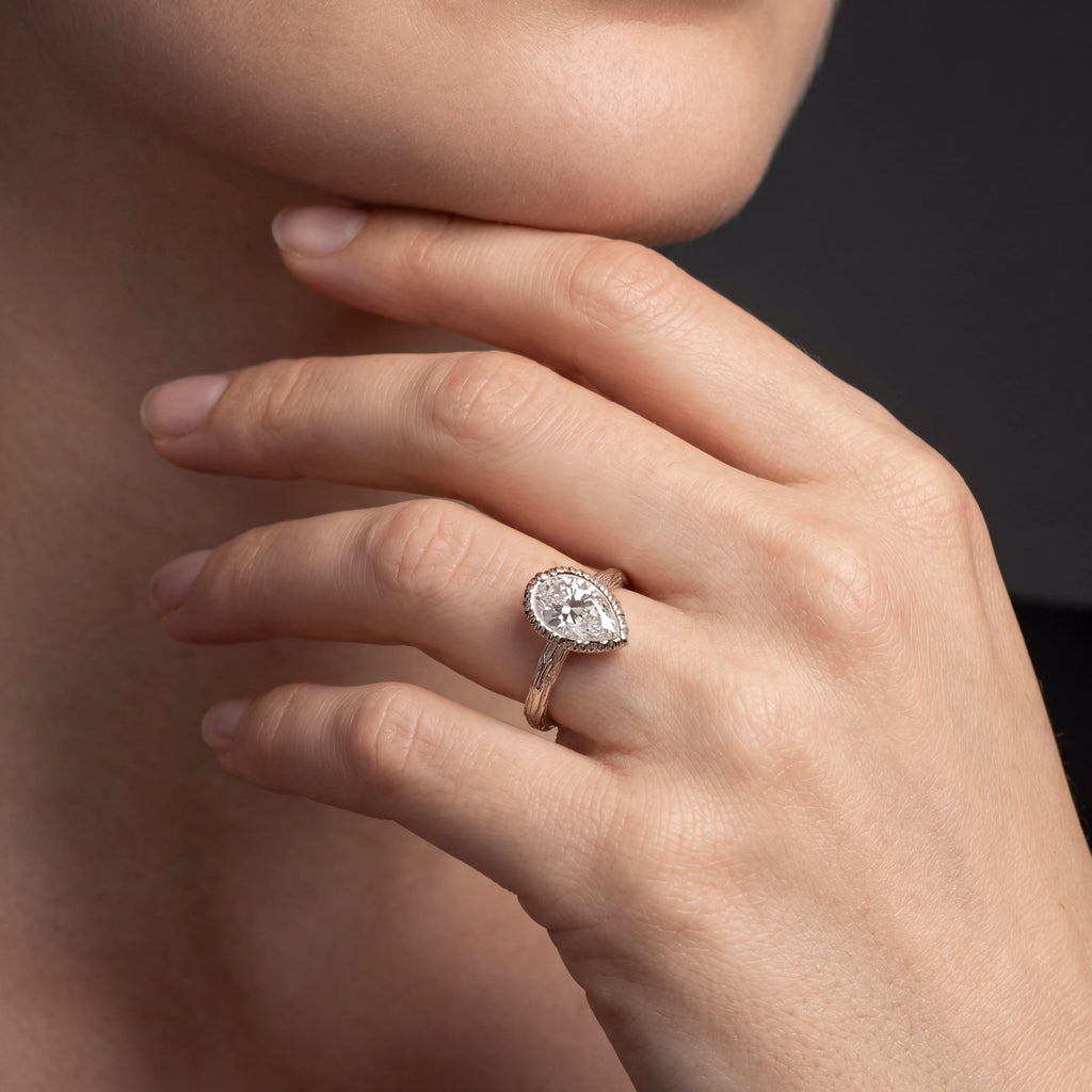 Pear Lab-Grown Diamond branch band engagement ring worn on the hand in 14K white gold