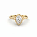 Pear Lab-Grown Diamond engagement ring, angled view of the bezel-set stone and bark-textured branch band in 14K yellow gold