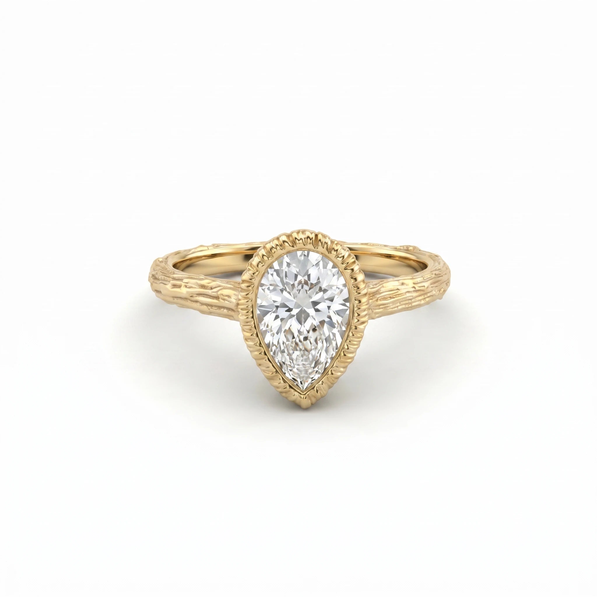 Pear Lab-Grown Diamond engagement ring, angled view of the bezel-set stone and bark-textured branch band in 14K yellow gold