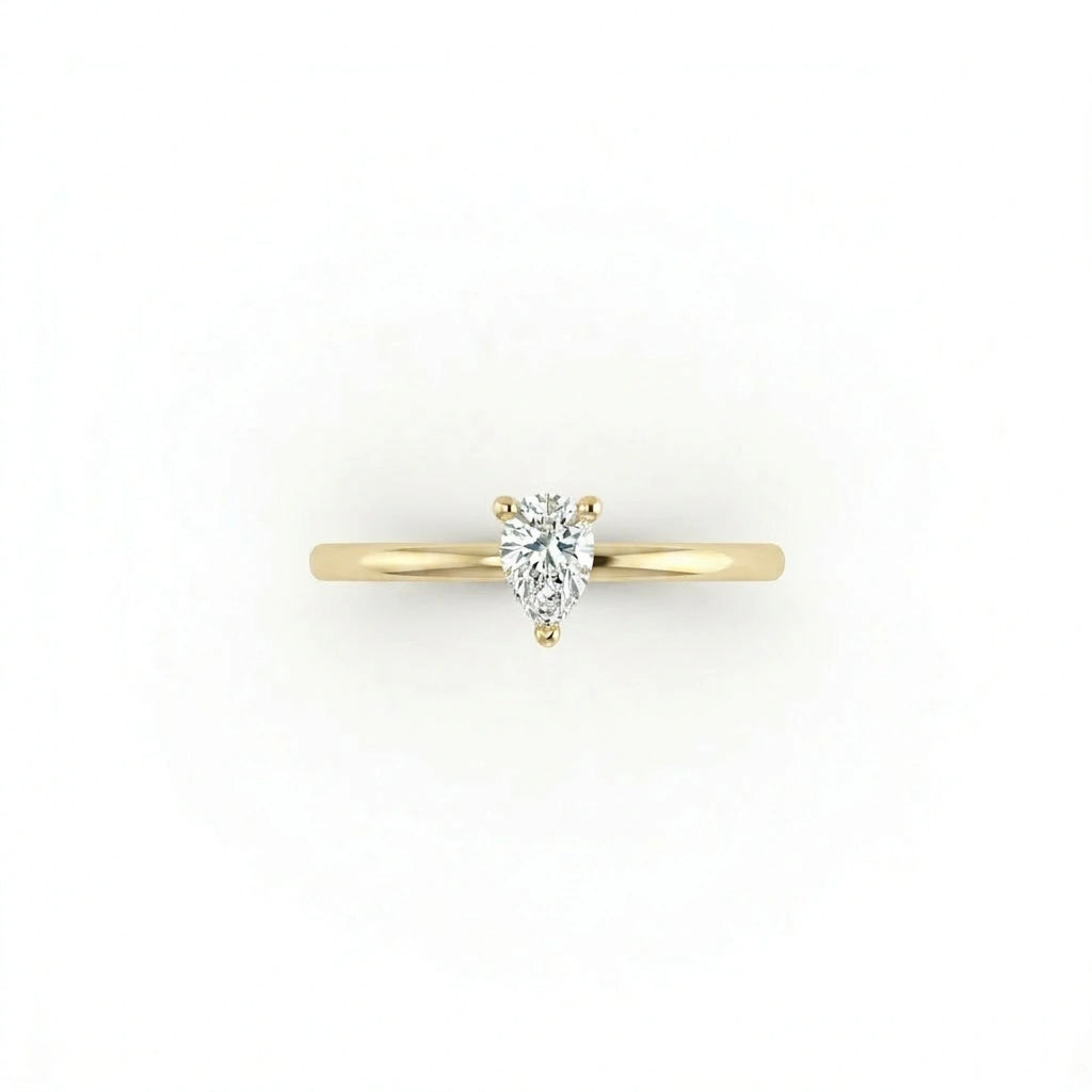Top view of pear solitaire ultra thin engagement ring in solid 14K yellow gold