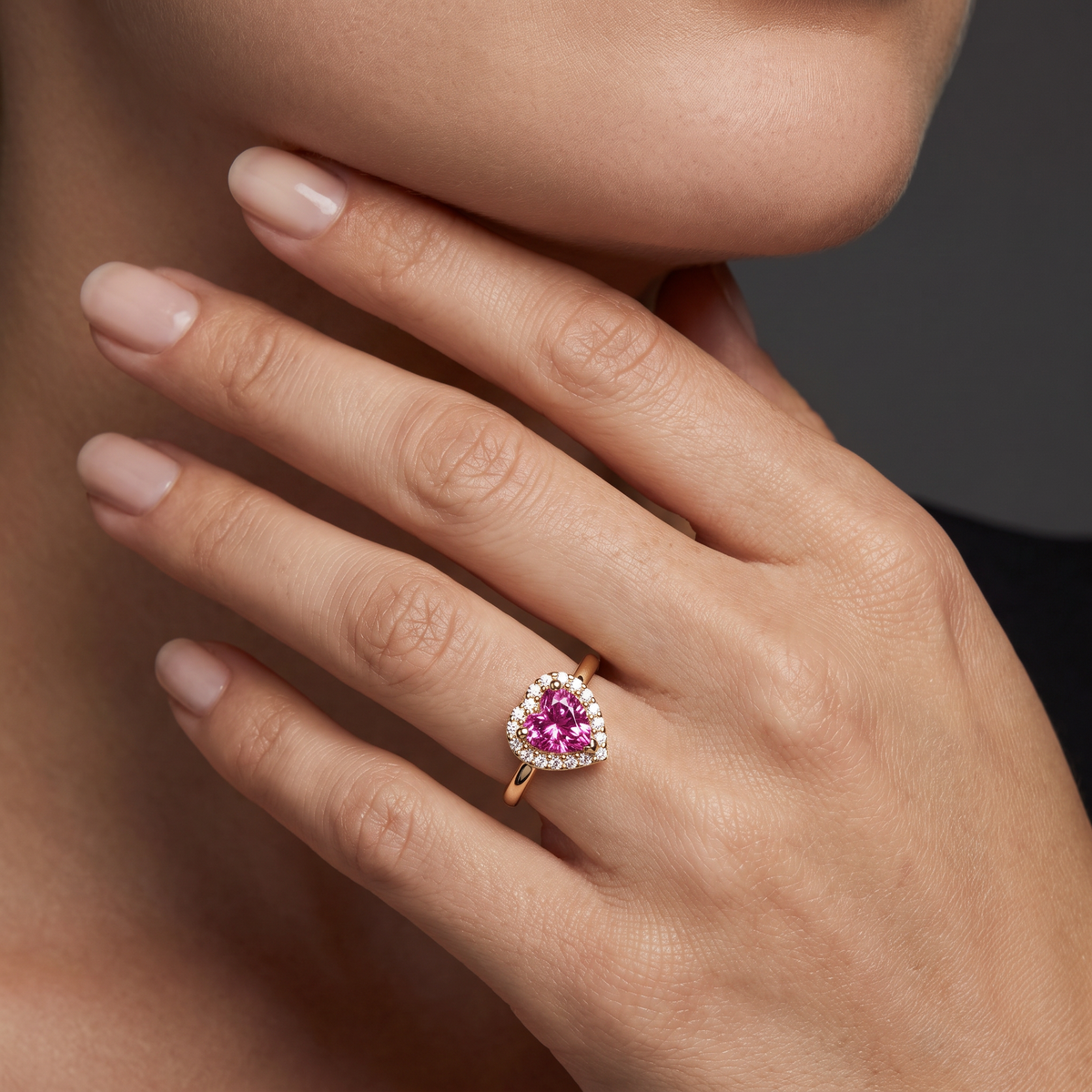 Pink tourmaline heart promise ring in 14K rose gold worn on the hand