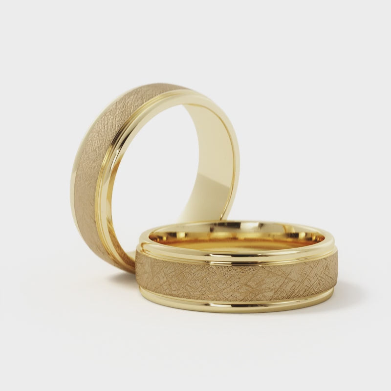 Cross-brushed wedding band finish in solid 14K gold showing textured surface under natural light