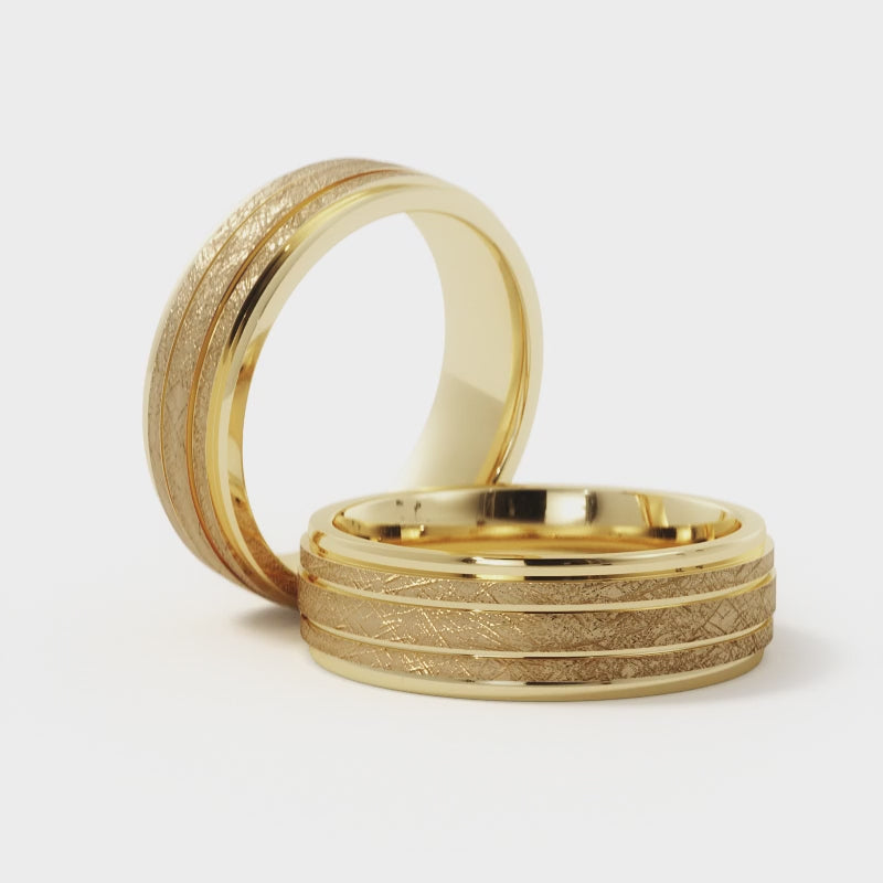 Video of a men's 7mm ice finish grooved wedding band in 14K yellow gold, showing the textured bands catching light between polished grooves