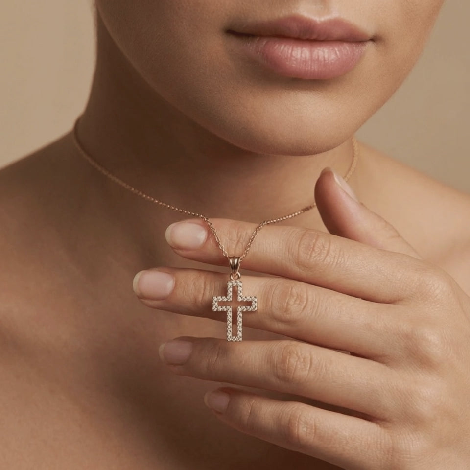 Close-up of 14K yellow gold Radiant pavé diamond cross necklace worn on model holding pendant video