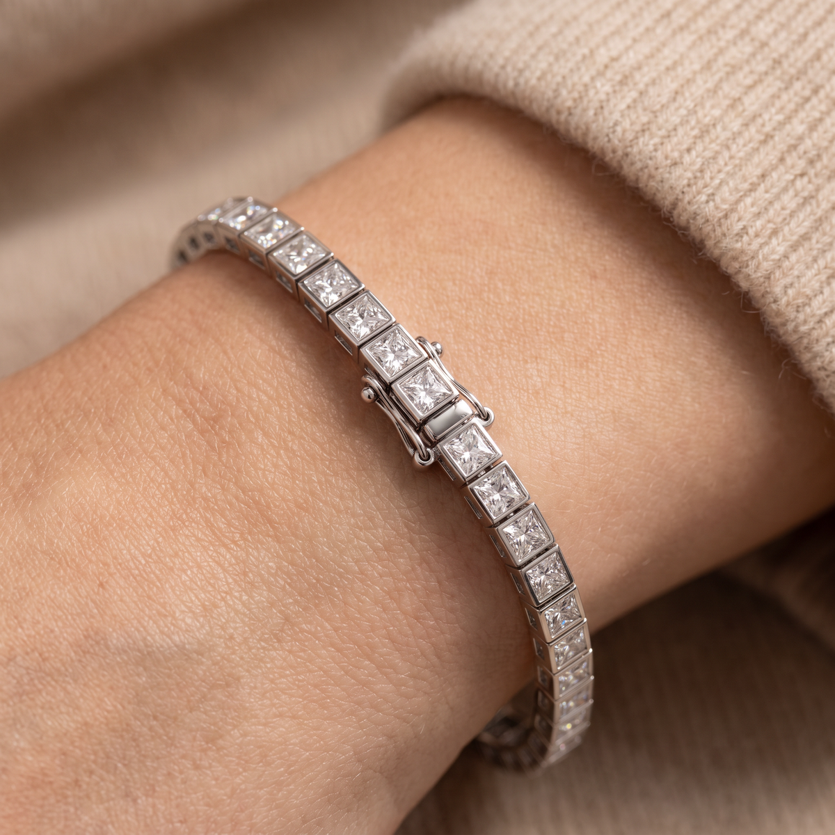 Princess cut bezel tennis bracelet in 14K white gold with Lab-Grown Diamonds worn on the wrist