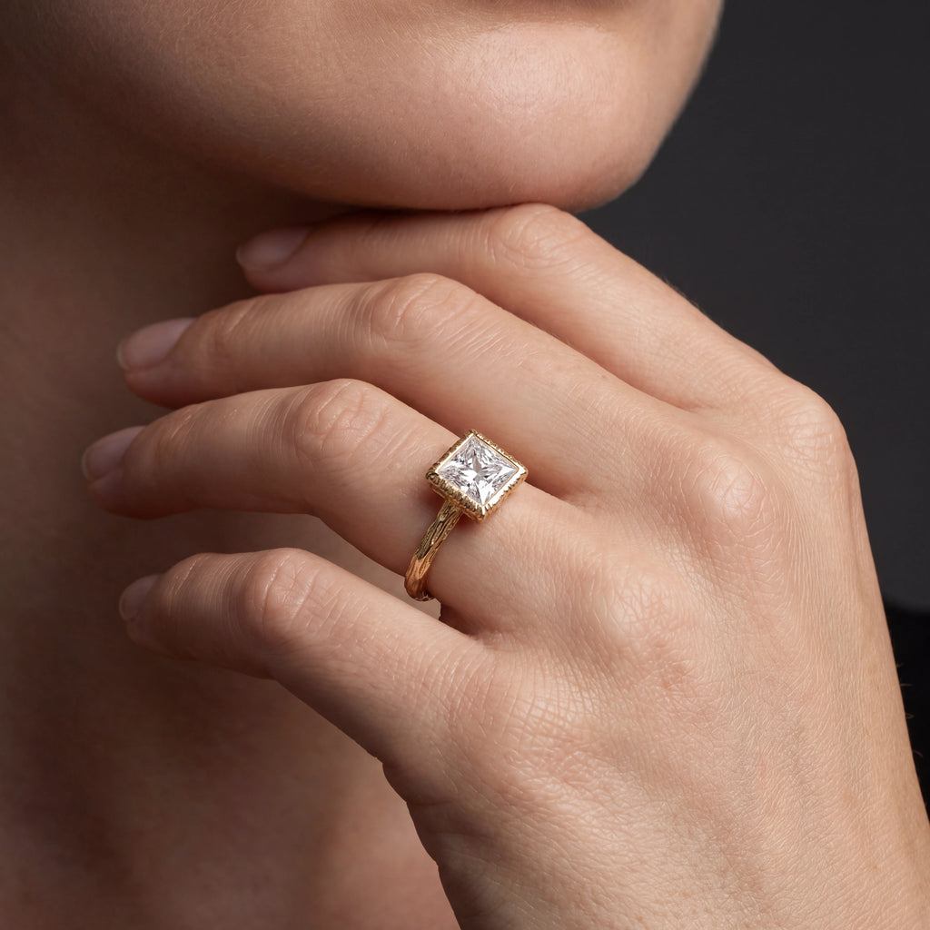 Princess cut Lab-Grown Diamond engagement ring with hand-carved branch band in 14K rose gold, worn on hand